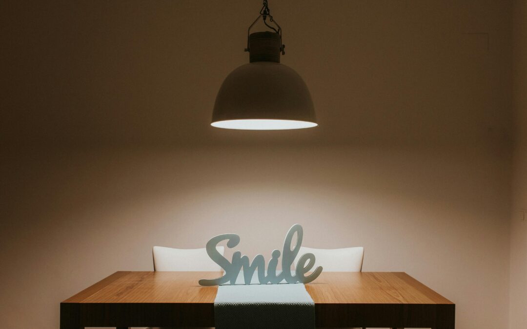 the word "smile" under a lamp on a desk