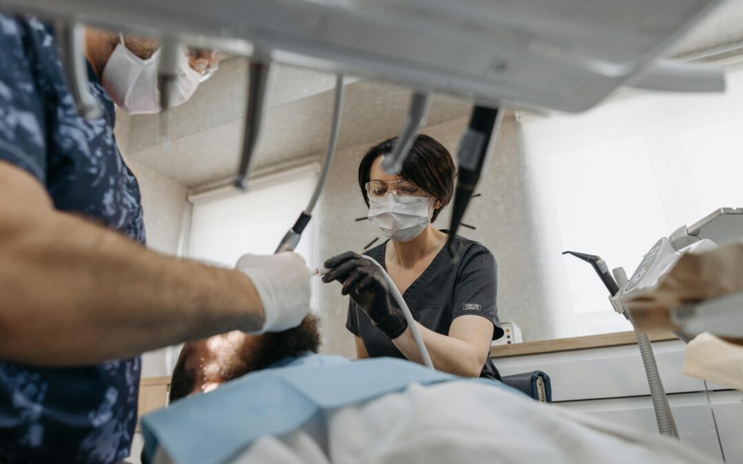 two dentists with equipment performing an operation